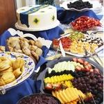 Table display with custom cake, scones, fresh fruits and hors devours